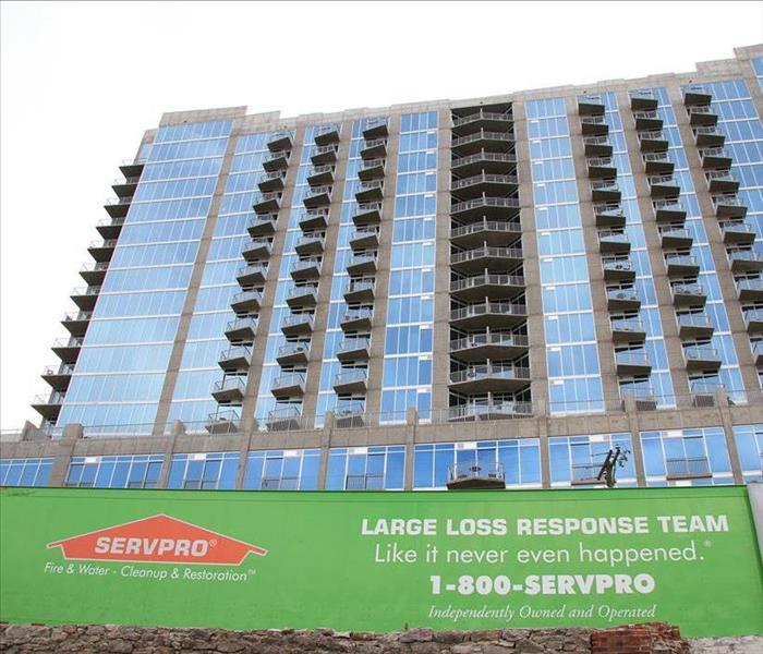 large glass building with servpro container infront