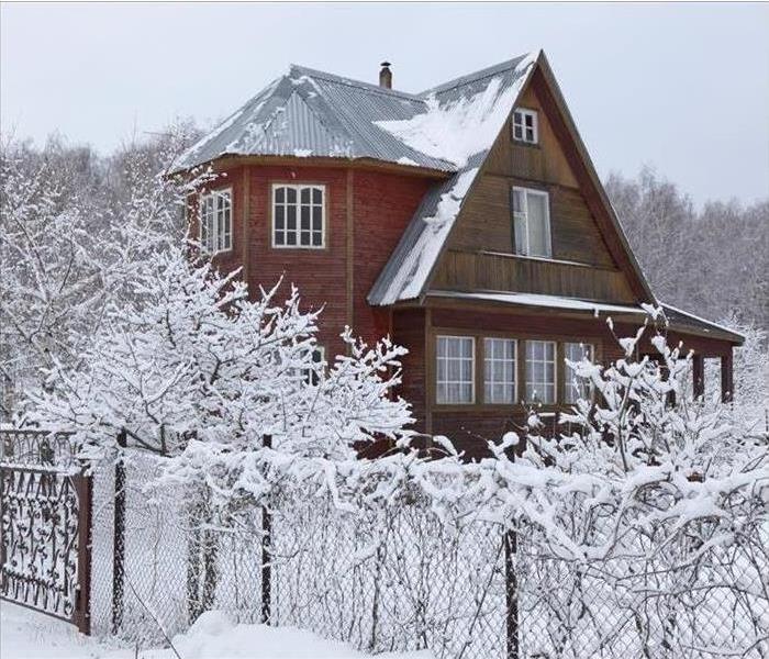 red house covered in snow