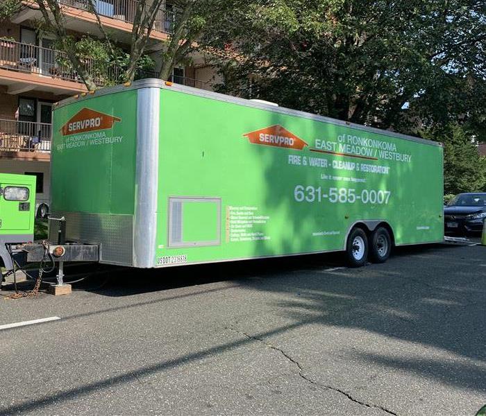 Green SERVPRO of Ronkonkoma East Meadow/Westbury Trailer on the street in front of Coop building