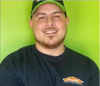 SERVPRO Crew member smiling in front of green background